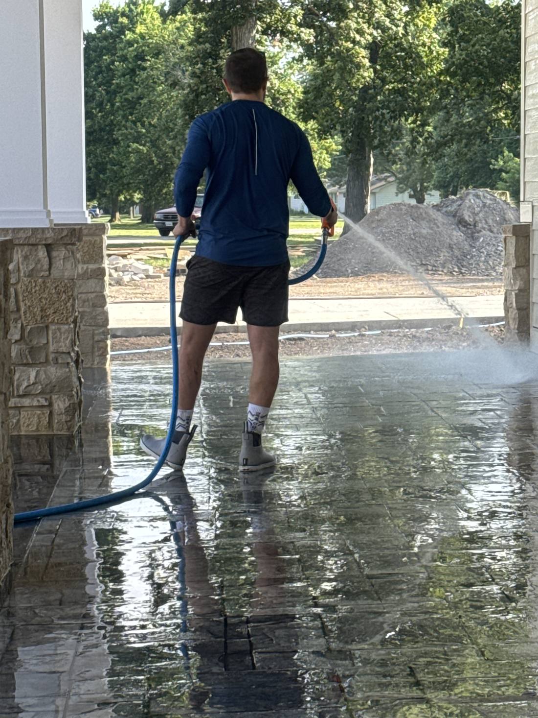 Stamped concrete patio being rinsed at a commercial property