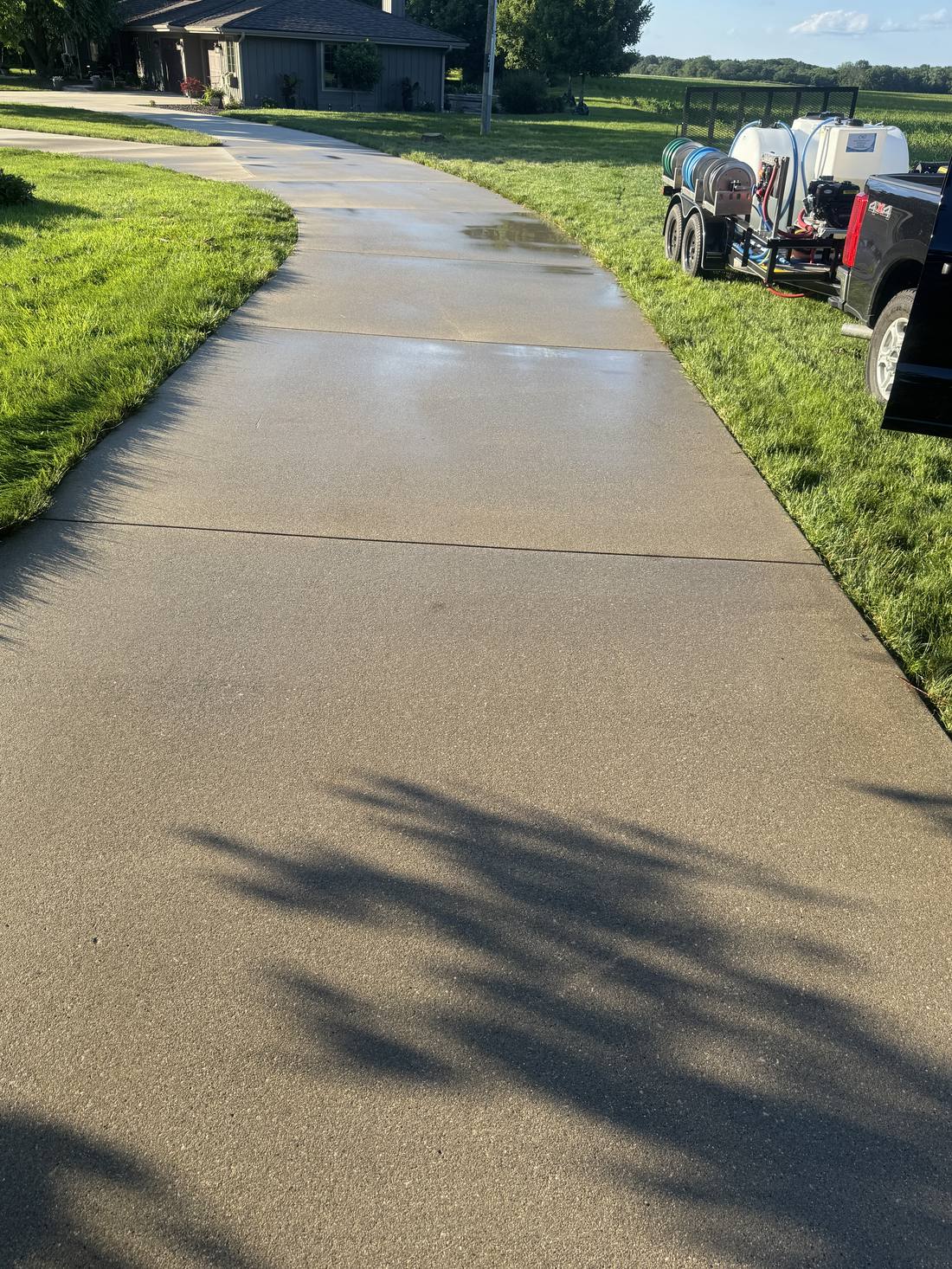 Clean concrete walkway with the On-Site Shine wash trailer on site